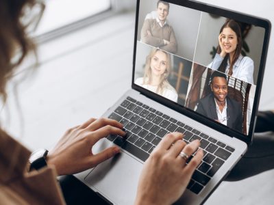 Online business meeting. Business team working from home in a video conference. 
The girl communicates via video call communication using laptop with her business colleagues about the future strategy